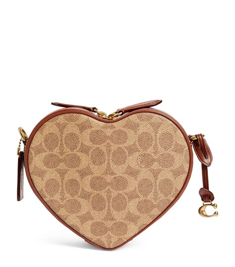 Heart coach purse - To determine whether a Coach handbag is authentic, examine the stitching, placement of the fabric and the interior of the bag. Coach handbags are made from high-quality materials a...